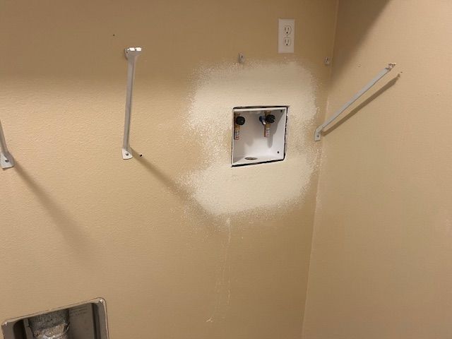 A ceiling with a hole in it and a garage door opener.