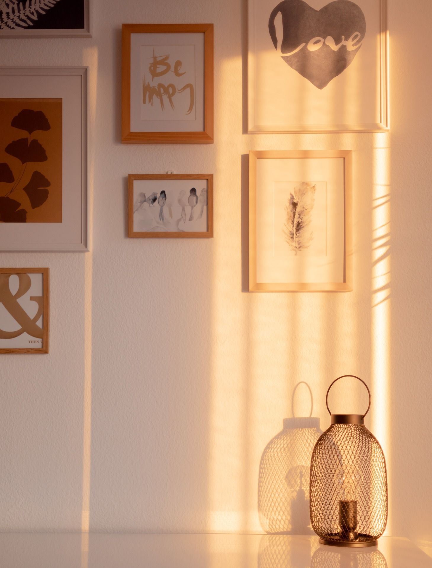 A wall with pictures on it including one that says be my