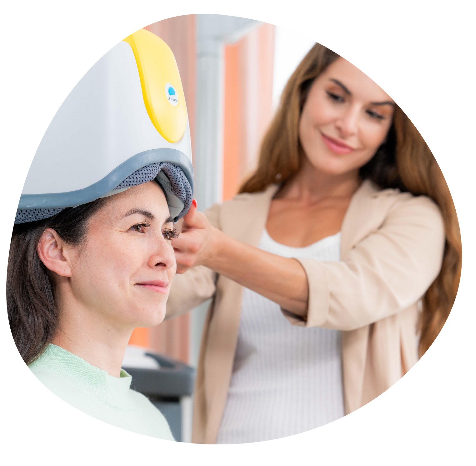 Patient under a dental scanner while a technician adjusts the equipment