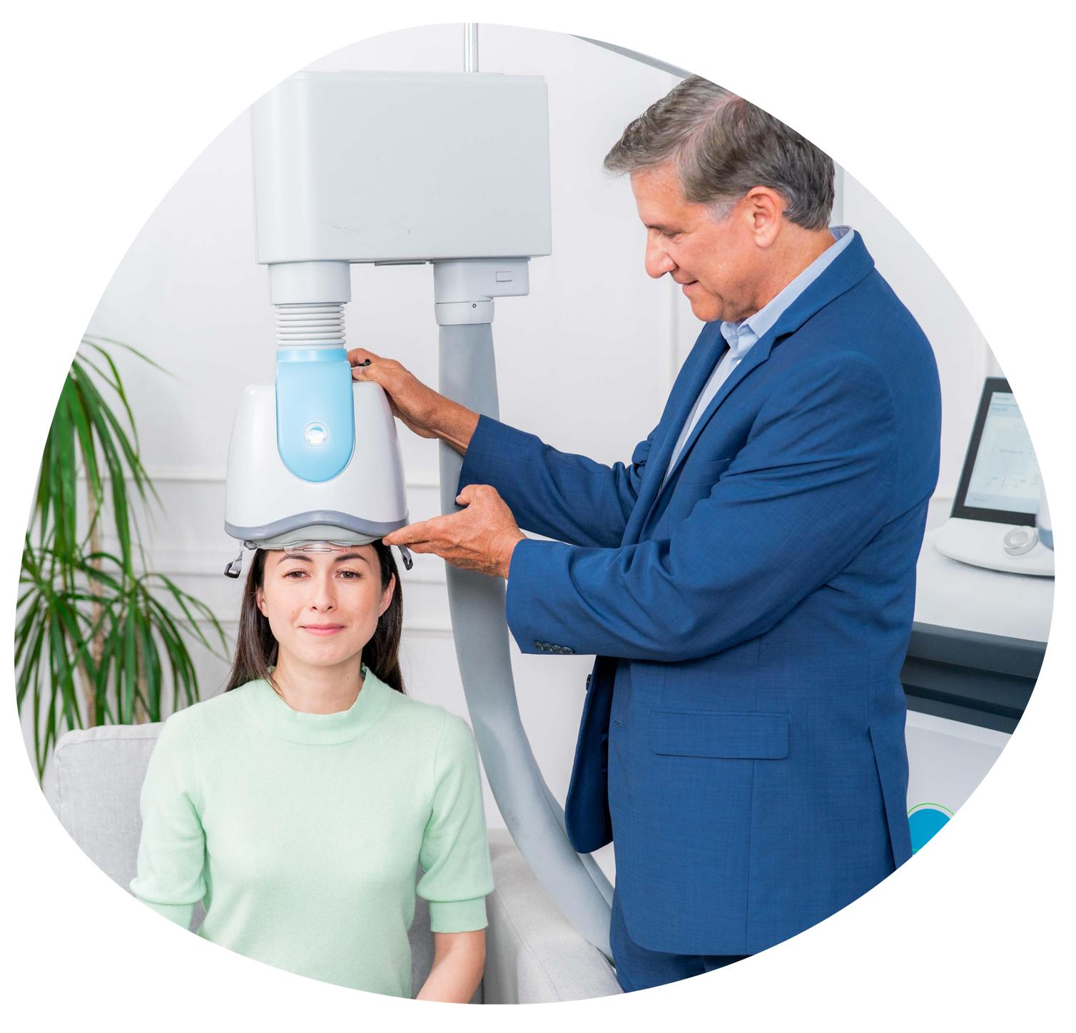 Dentist adjusting a patient’s head under an X-ray machine in a bright clinic