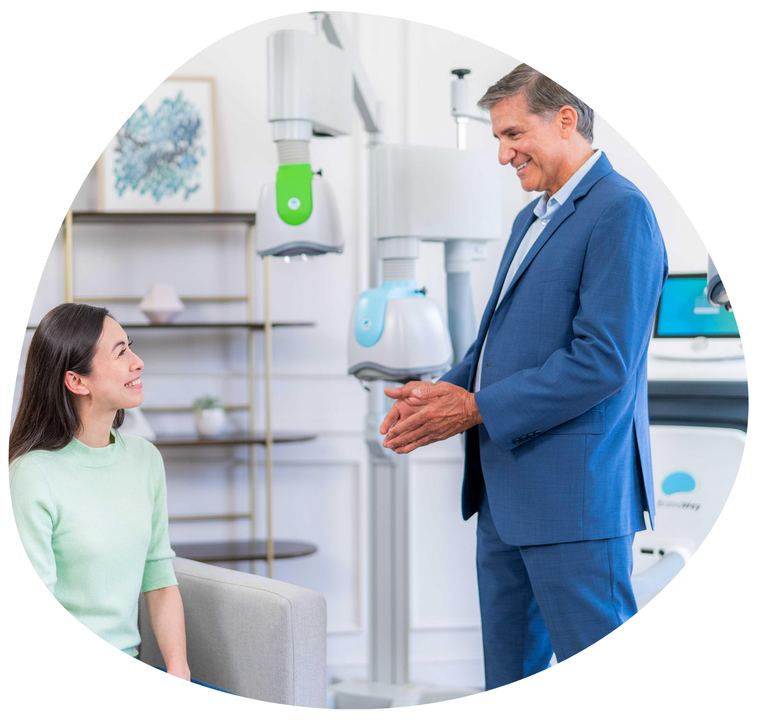 Dentist speaking with a seated patient in a bright, modern dental clinic