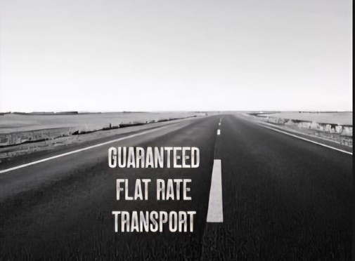 Black-and-white road with text: “Guaranteed Flat Rate Transport.”