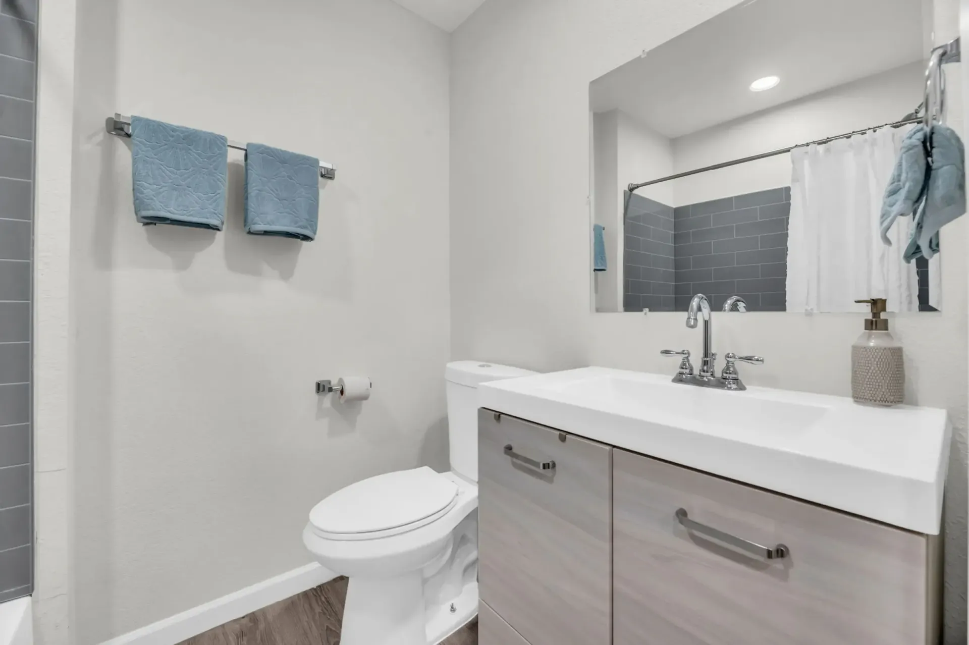 a bathroom with a toilet a sink and a mirror