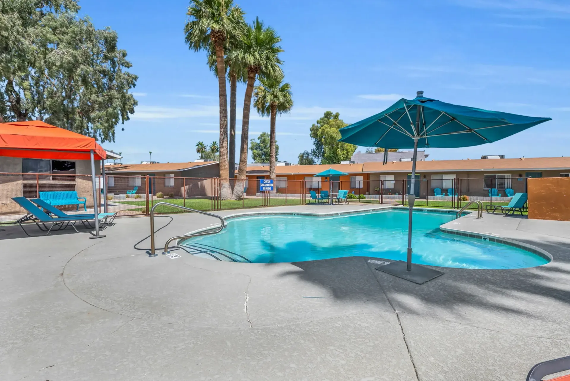 a swimming pool with umbrellas and chairs around it