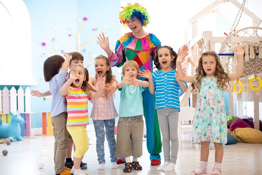 clown standing behind the children