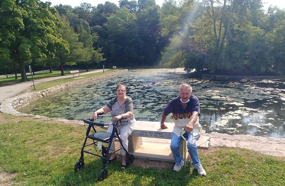 elderly man and woman sitting by pond | best assisted living apartments near springfield and nixa mo
