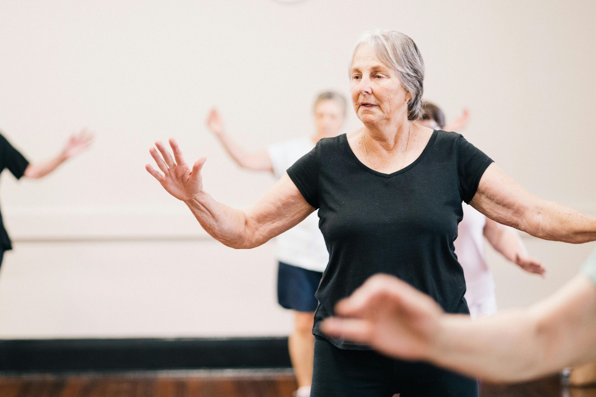 elderly woman and other residents dancing | best memory care in ozark mo