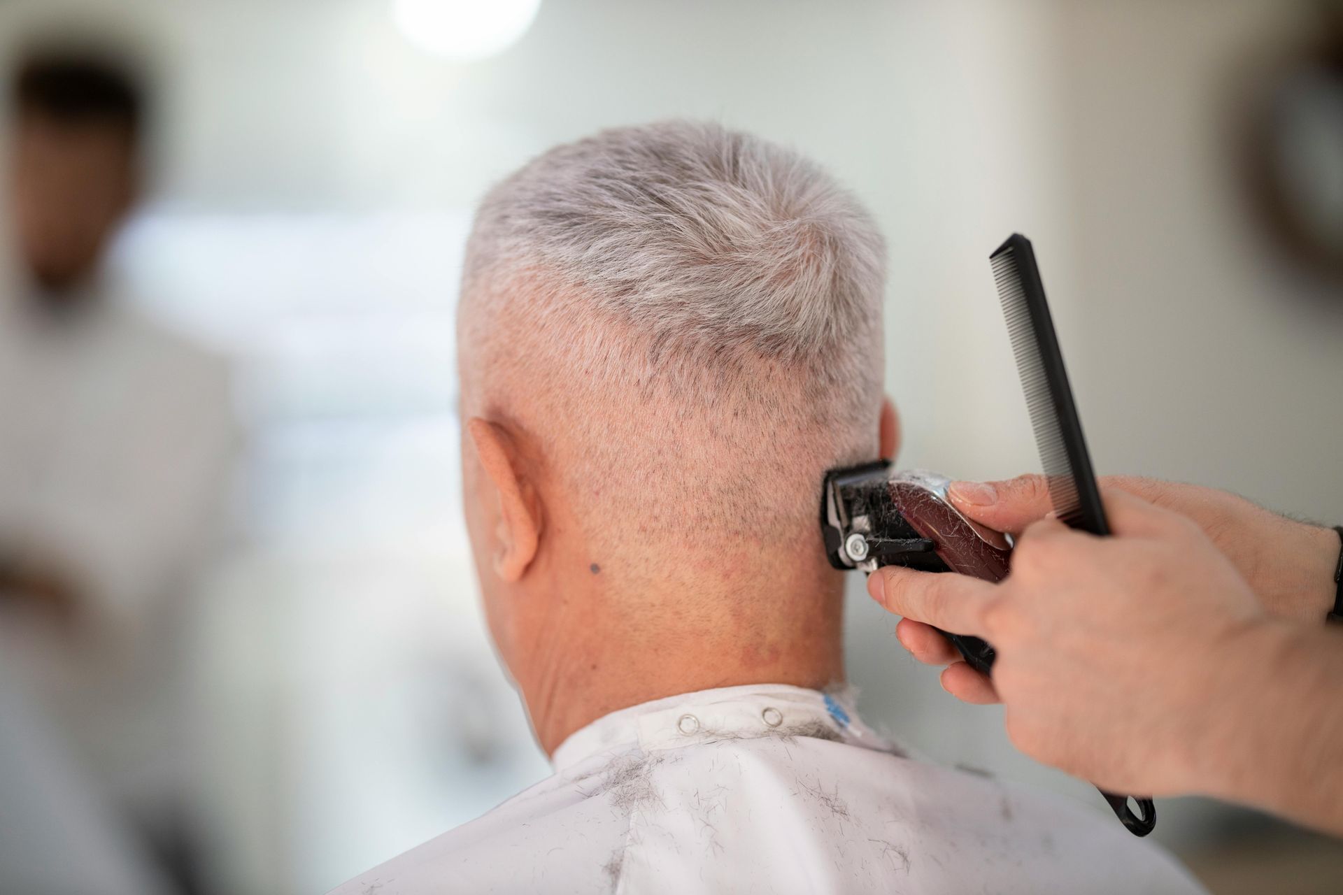 senior man getting haircut at our on-site barbershop | Assisted living Ozark & Springfield MO