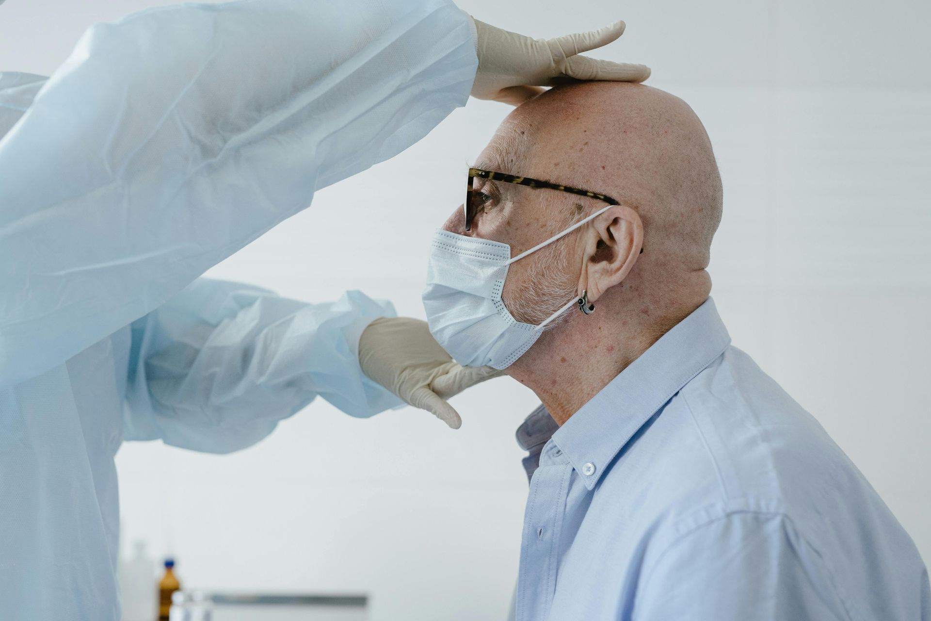 A man wearing a mask is being examined by a doctor | On Site medical assisted living in ozark mo