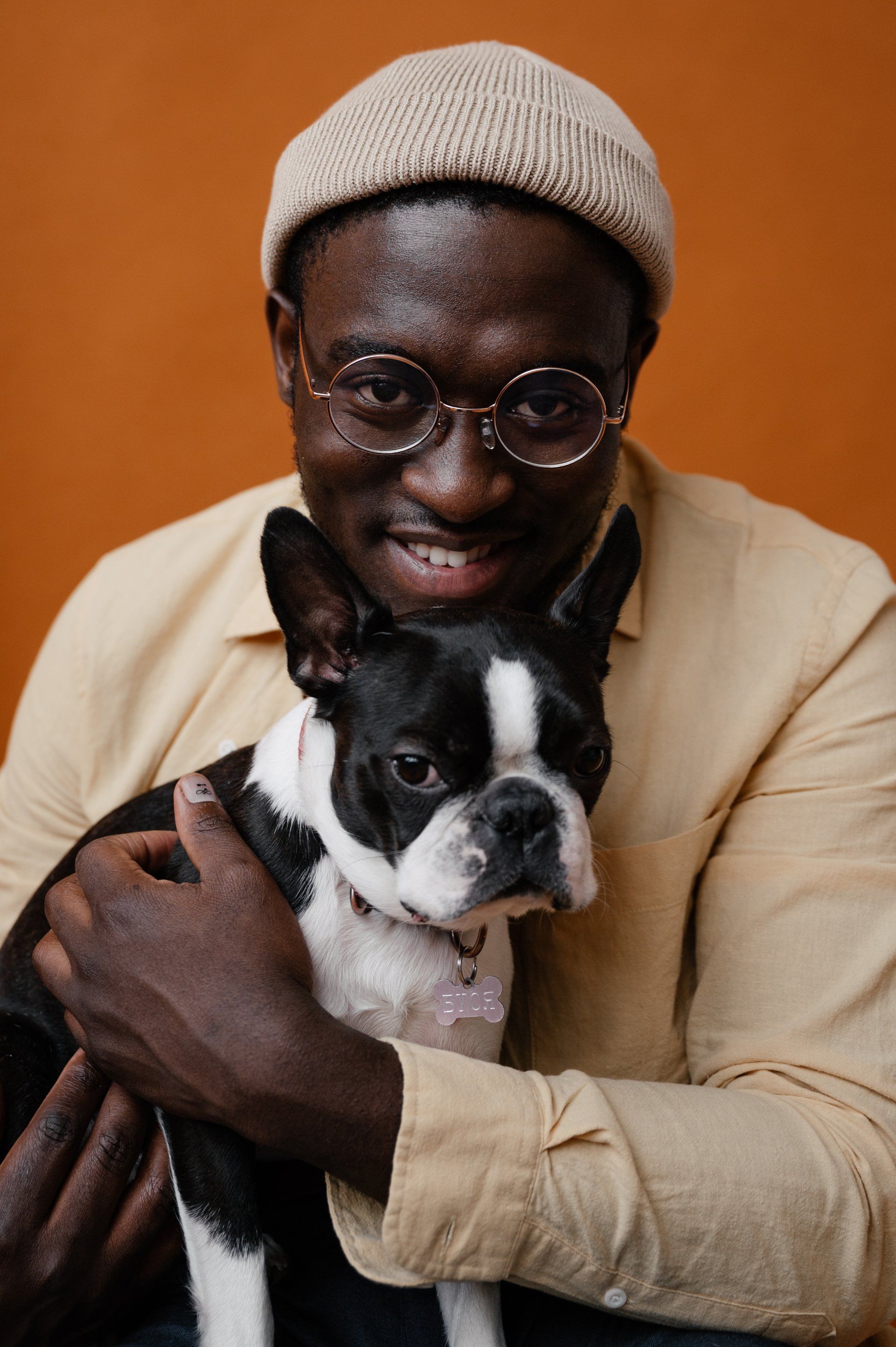 Man holding a dog in his arms and smiling