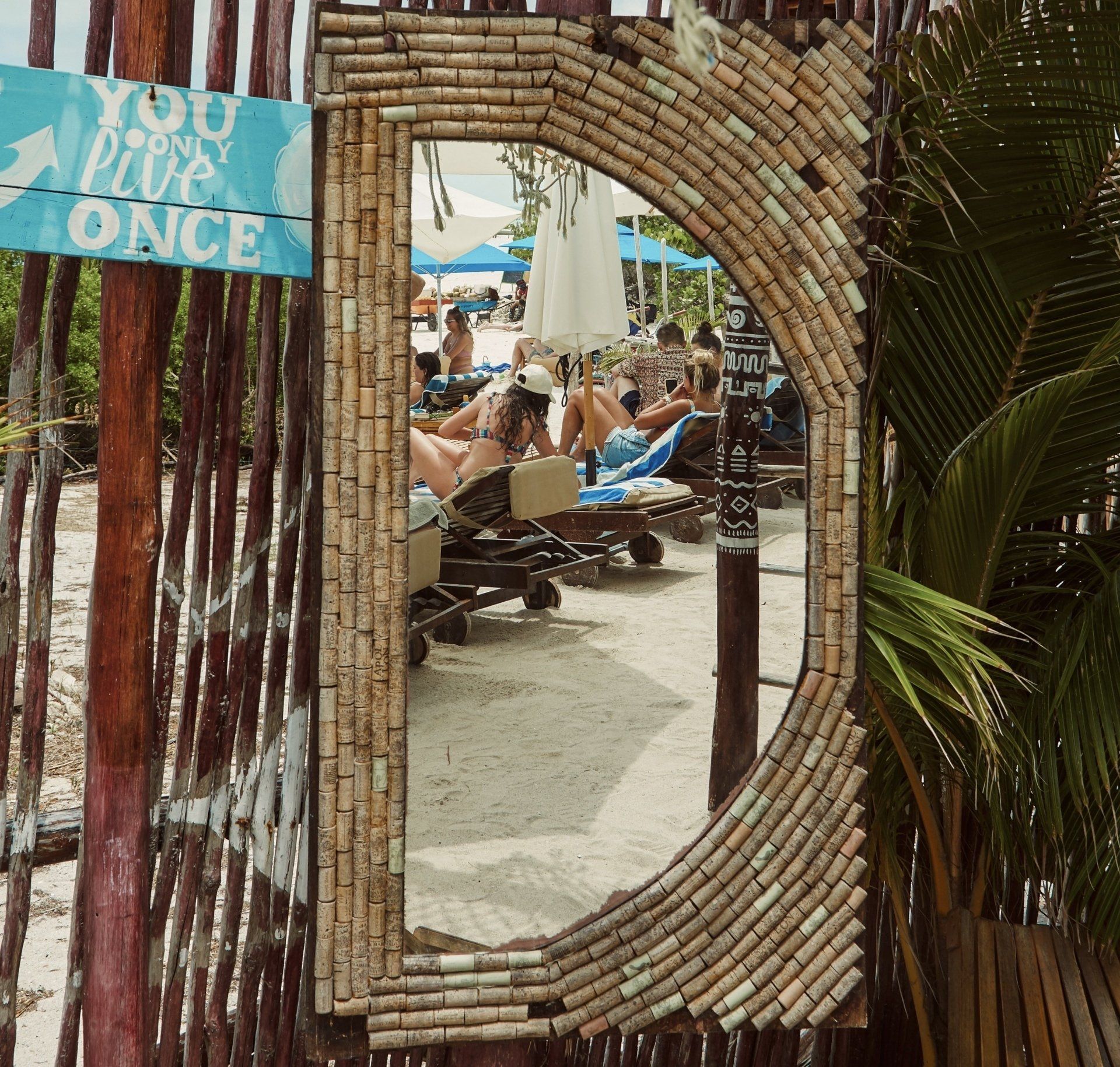 A mirror with a sign that says you live once