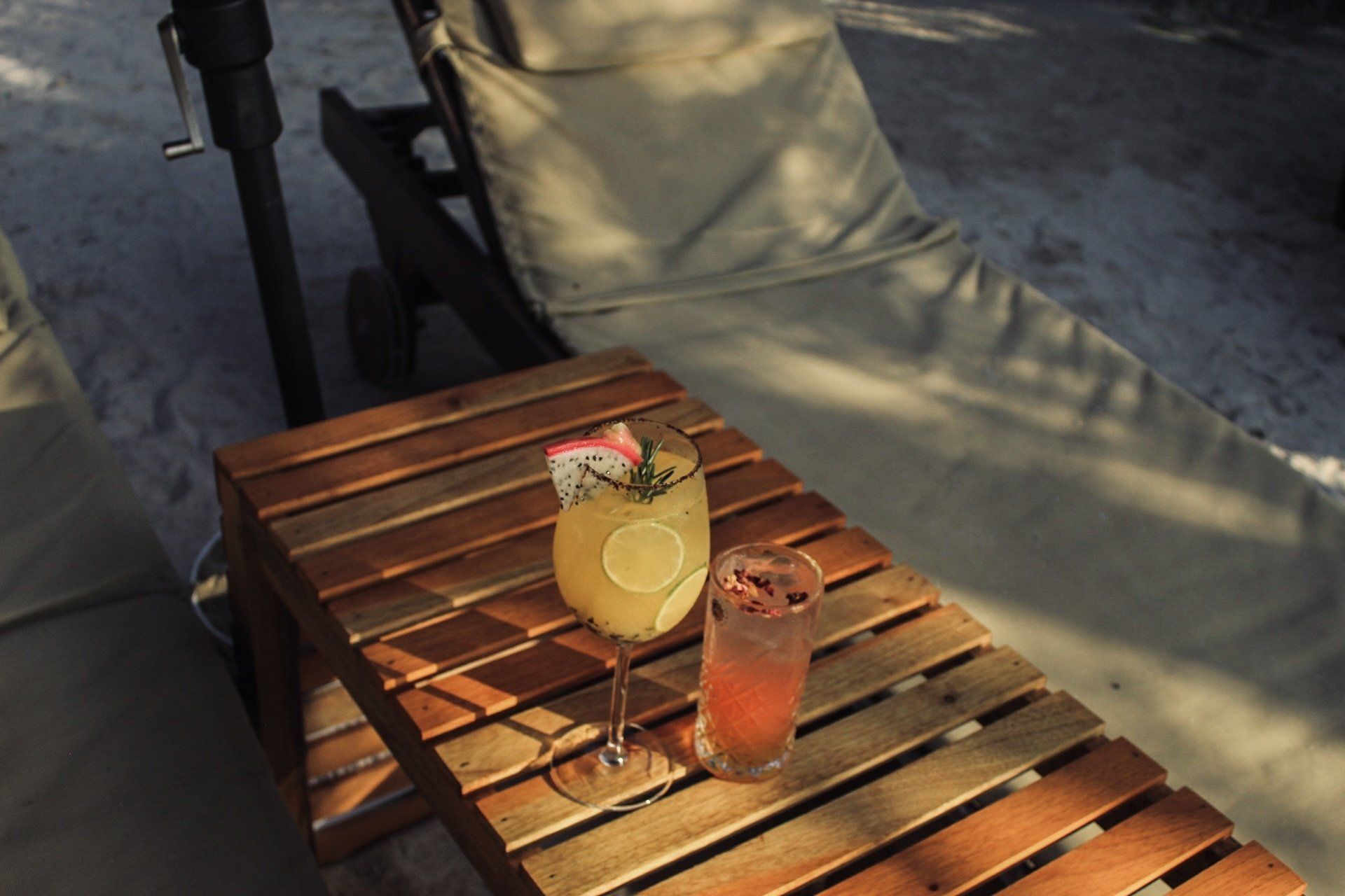 Two drinks are sitting on a wooden table.