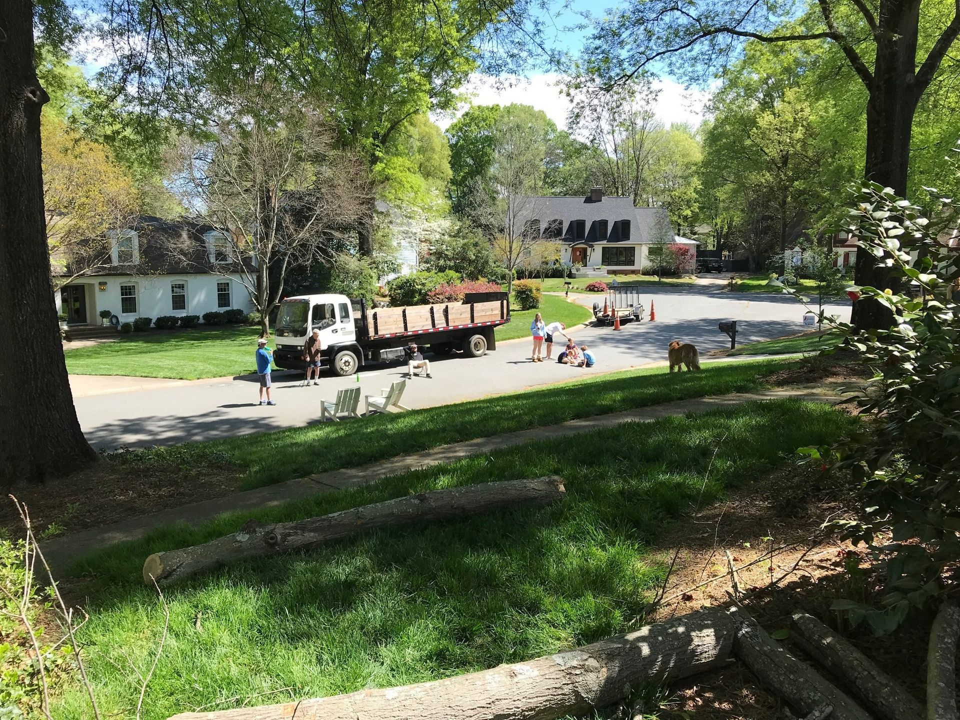 A dump truck is parked on the side of the road in a residential neighborhood.