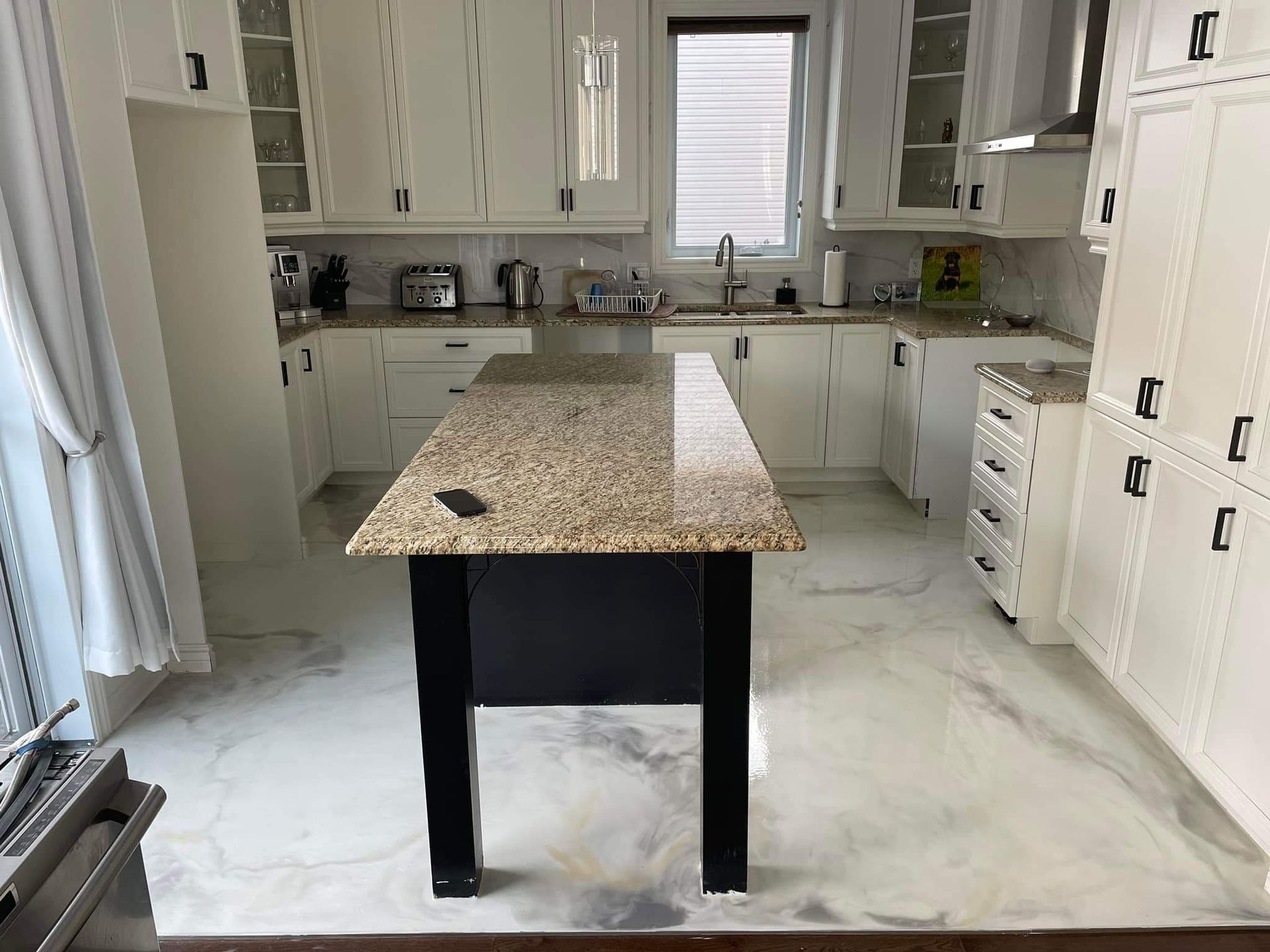 A kitchen with a large island in the middle of it.