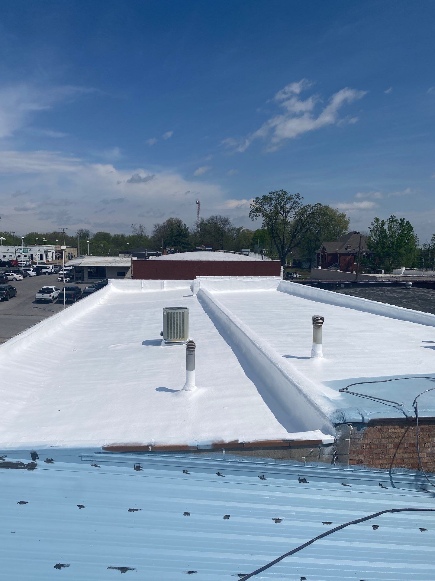 The roof of a building with a white roof and a blue roof.