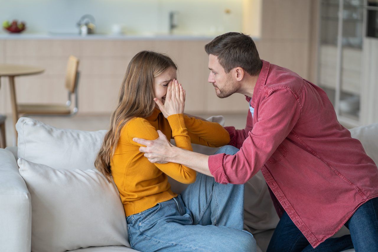 man screaming at a scared crying woman
