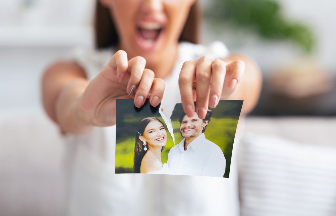 Angry Woman Ripping Wedding Photo With Ex-Husband