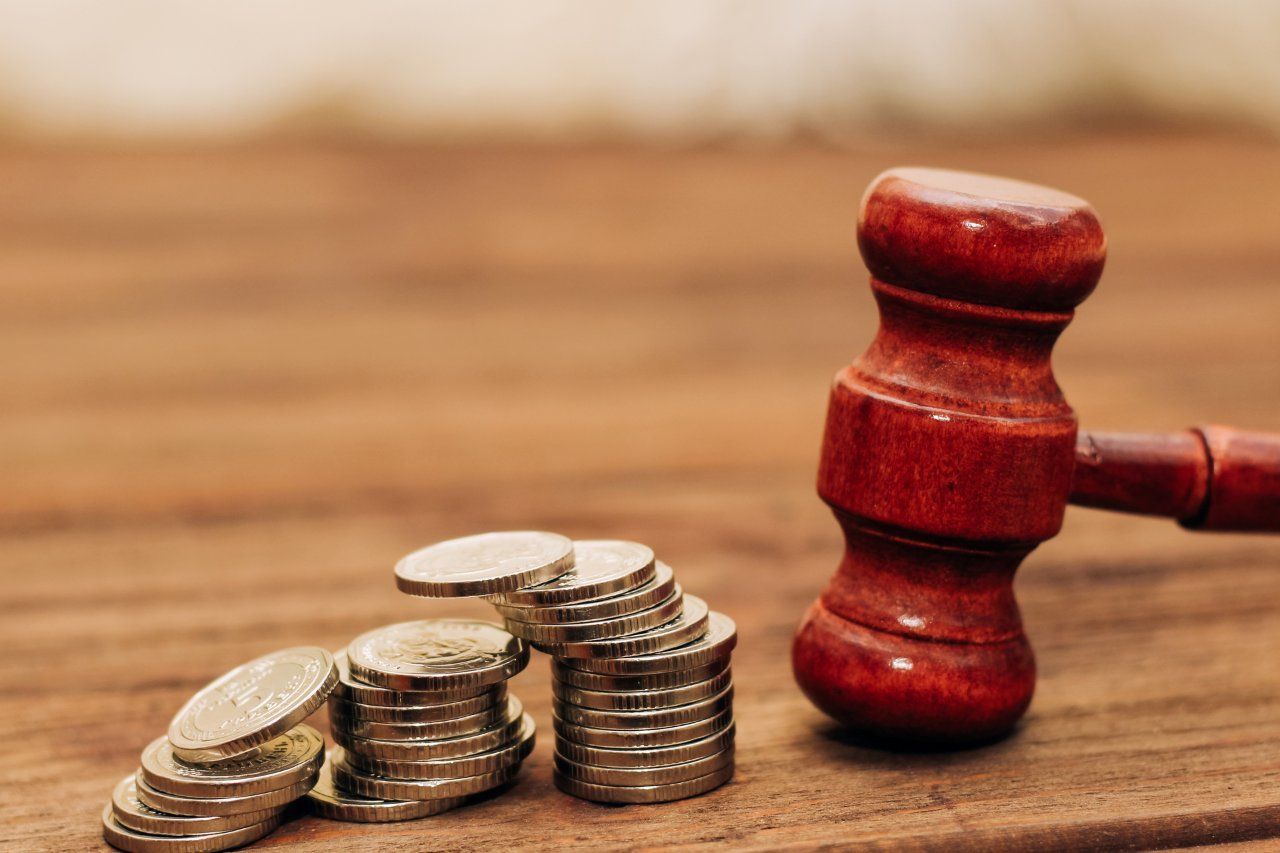 Judge's gavel on the table with coins