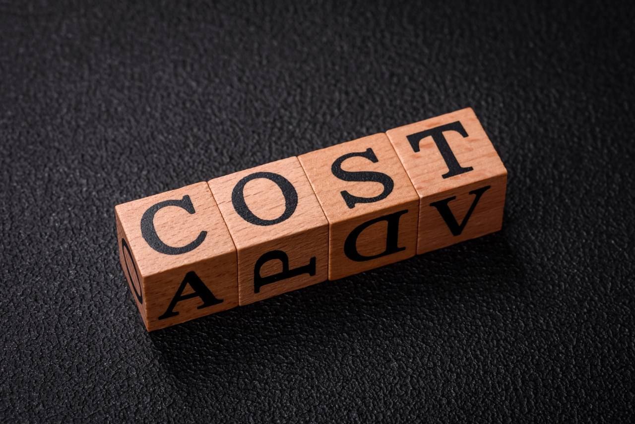 word cost spelled on wooden blocks
