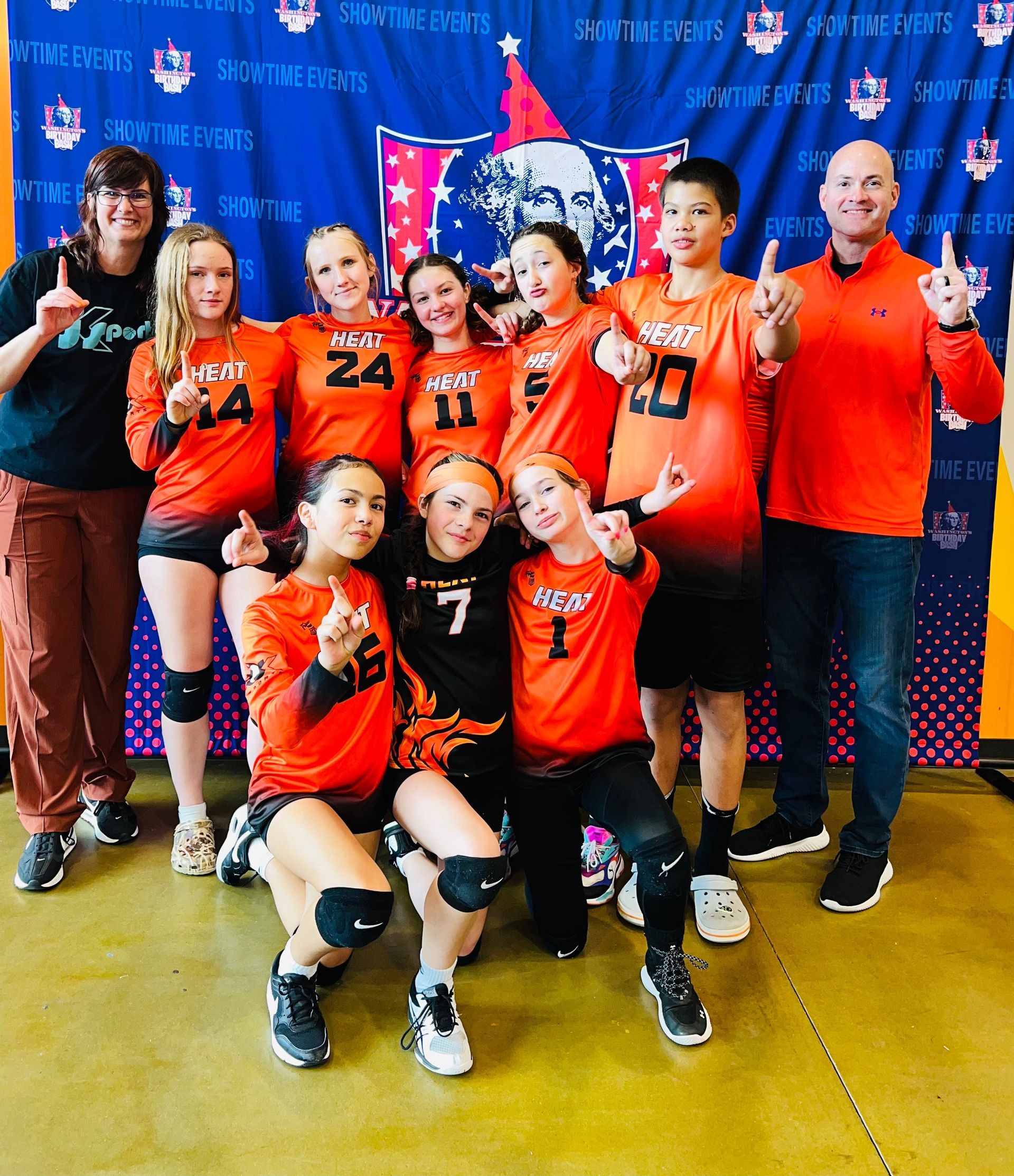 A group of people posing for a picture with one wearing the number 7