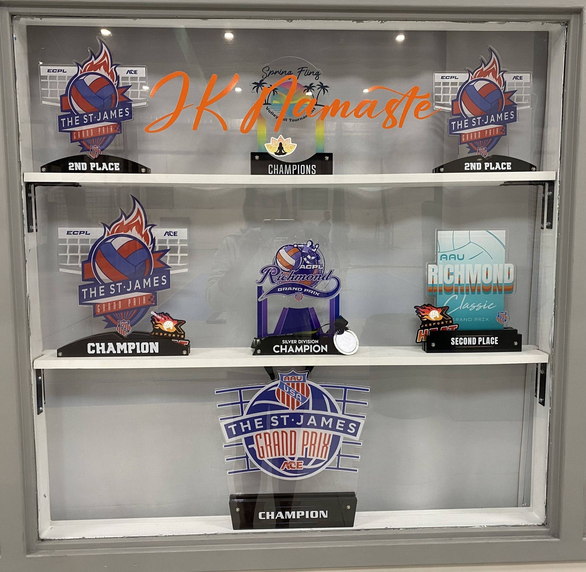 A display case with a lot of trophies on it