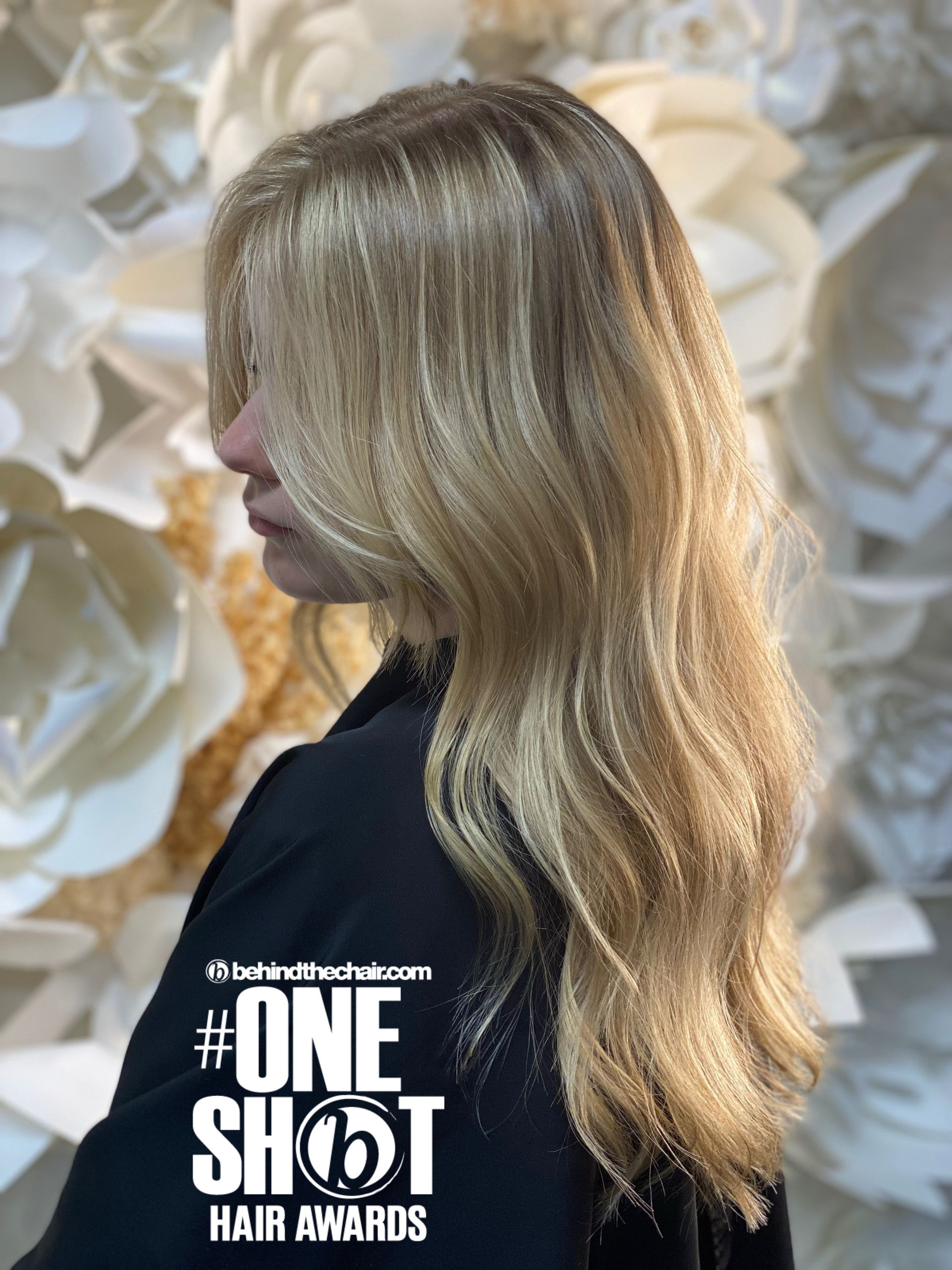 Side view of long wavy blonde hair with highlights.