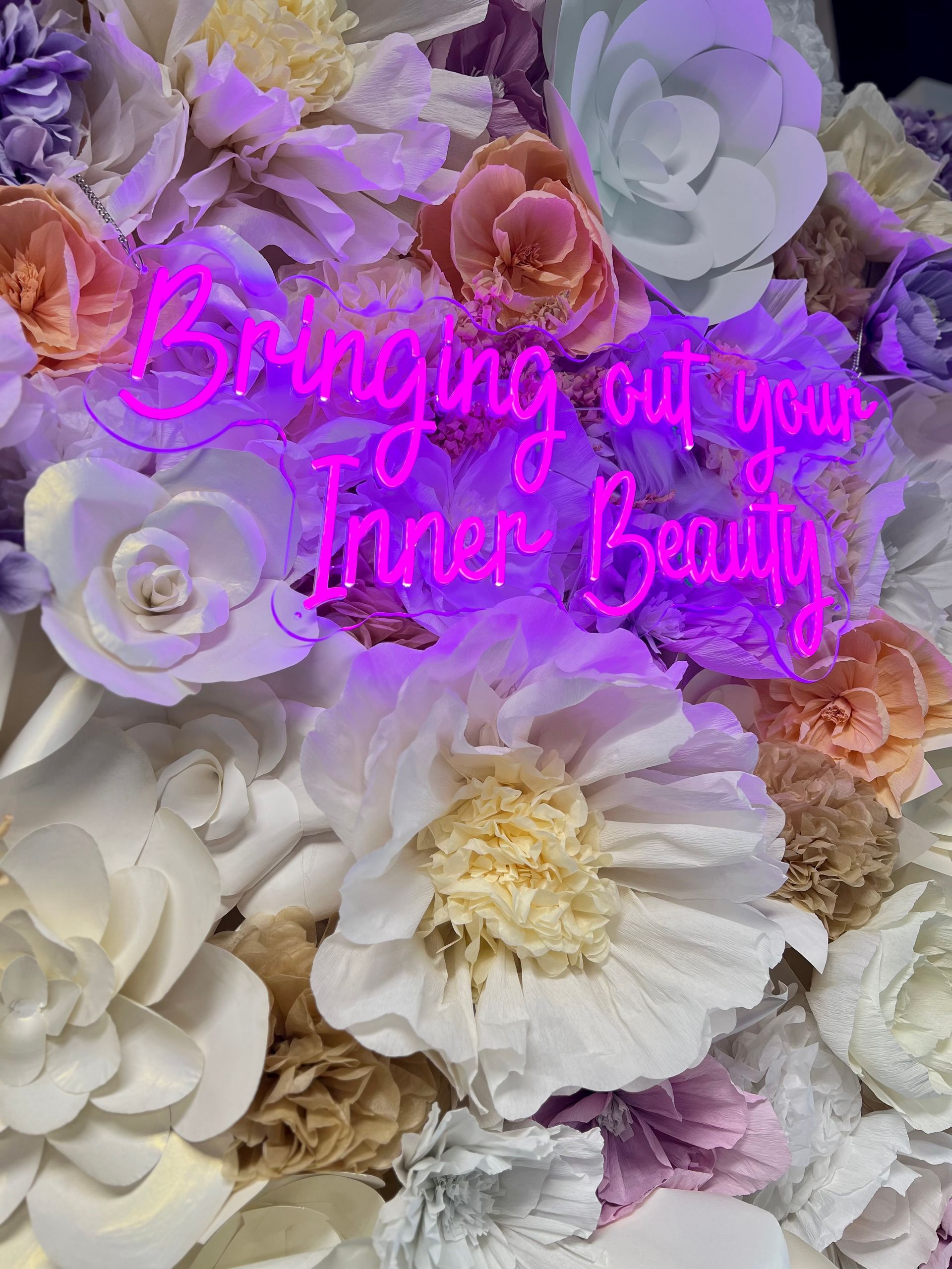 Neon sign reading ‘Bringing Out Your Inner Beauty’ on selfie wall at Salon Le Volume in Frisco, TX