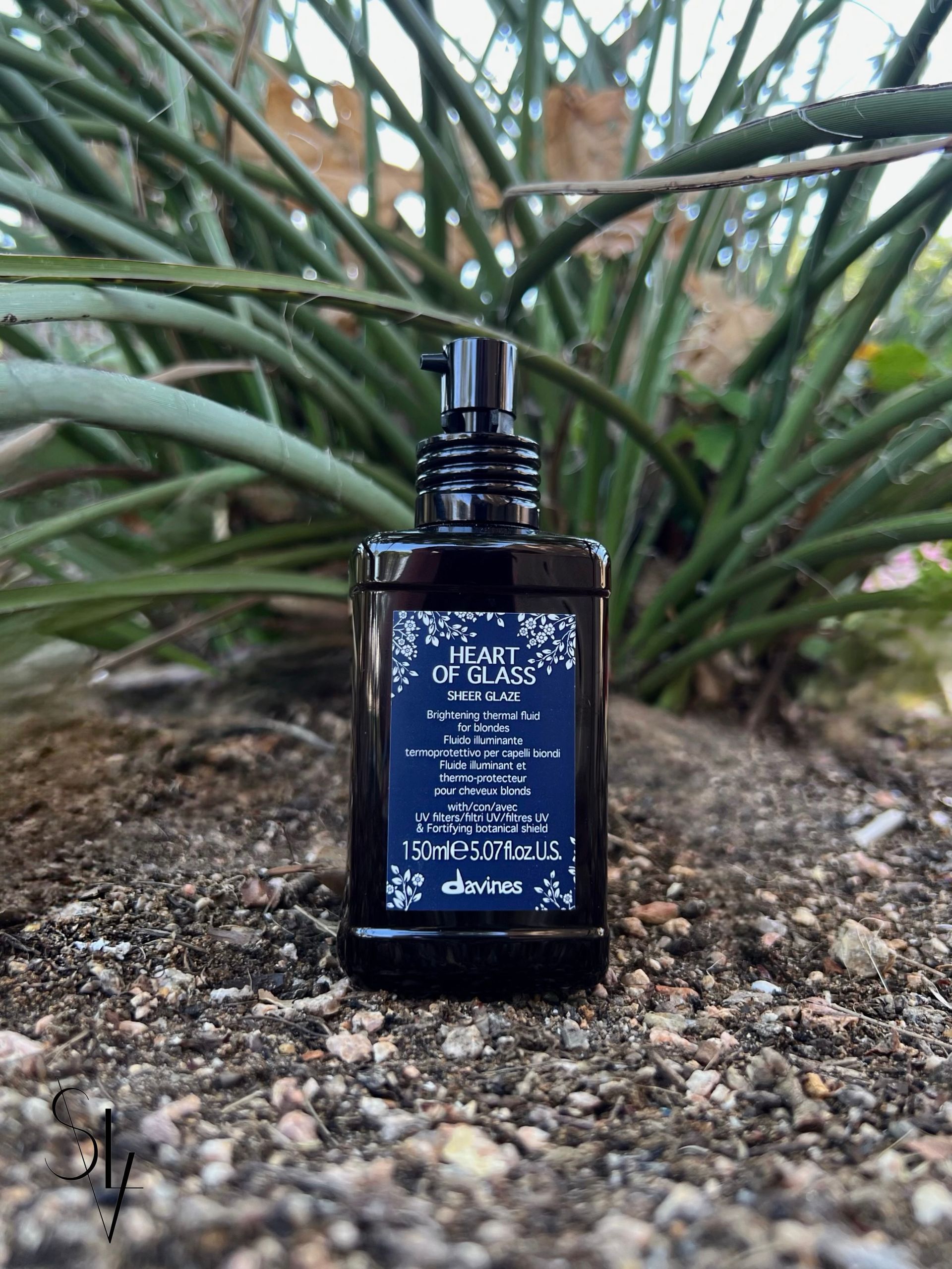 Dark brown bottle with blue label saying Heart of Glass Sheer Glaze.