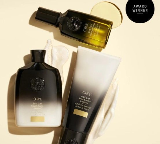 Dark brown & tan two-toned bottles of Oribe Gold Lust Shampoo and Conditioner.