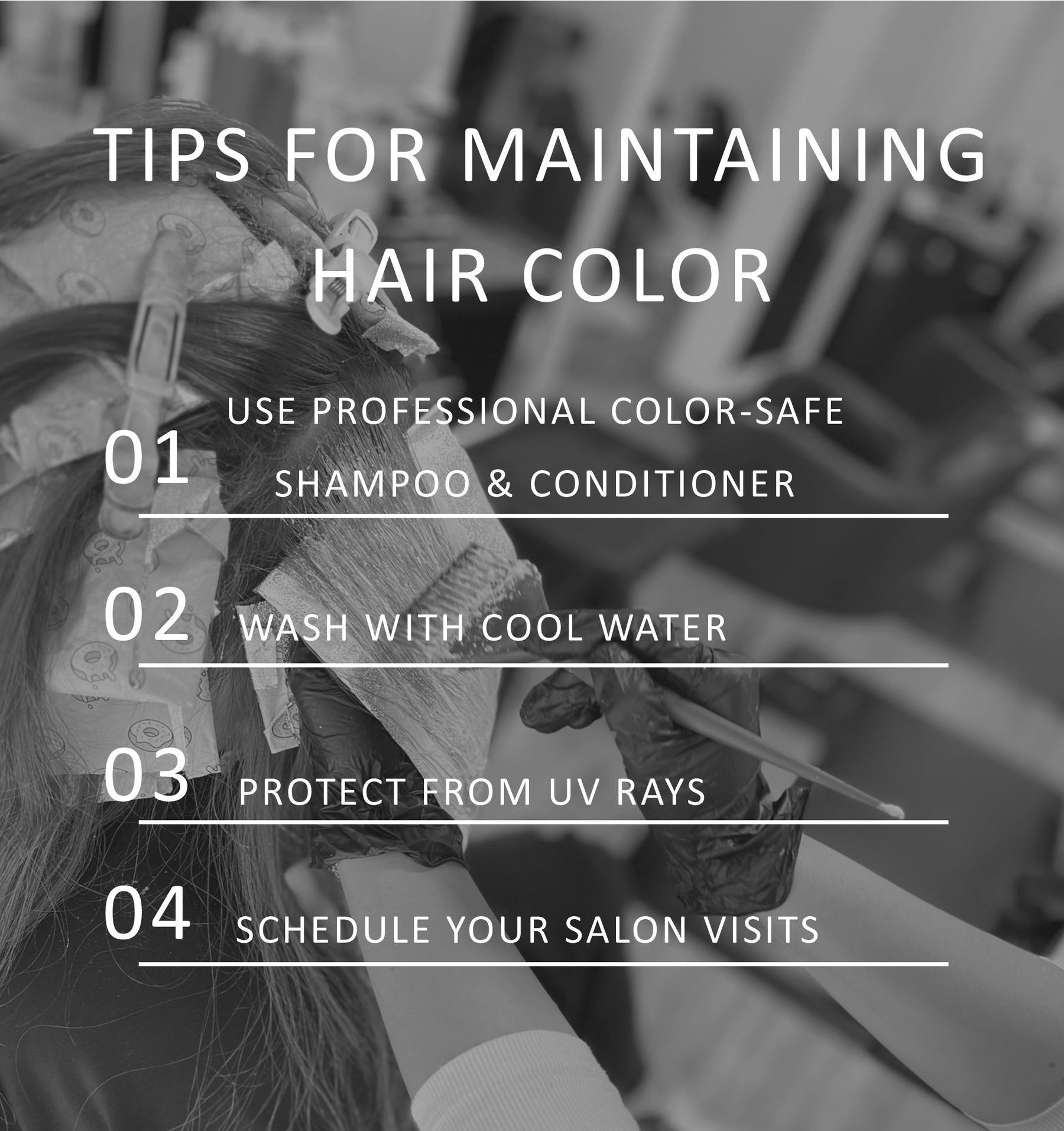 Close-up of Hair Stylist applying dye on a strand of hair with foil wrap underneath ready to be folded over the hair.