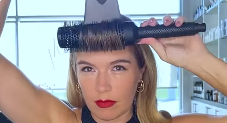 Kristina blow-drying her bangs