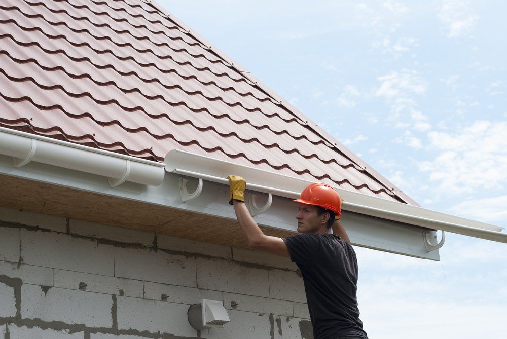 Man Installing Gutter on the Roof- Plumber in East Tamworth, NSW