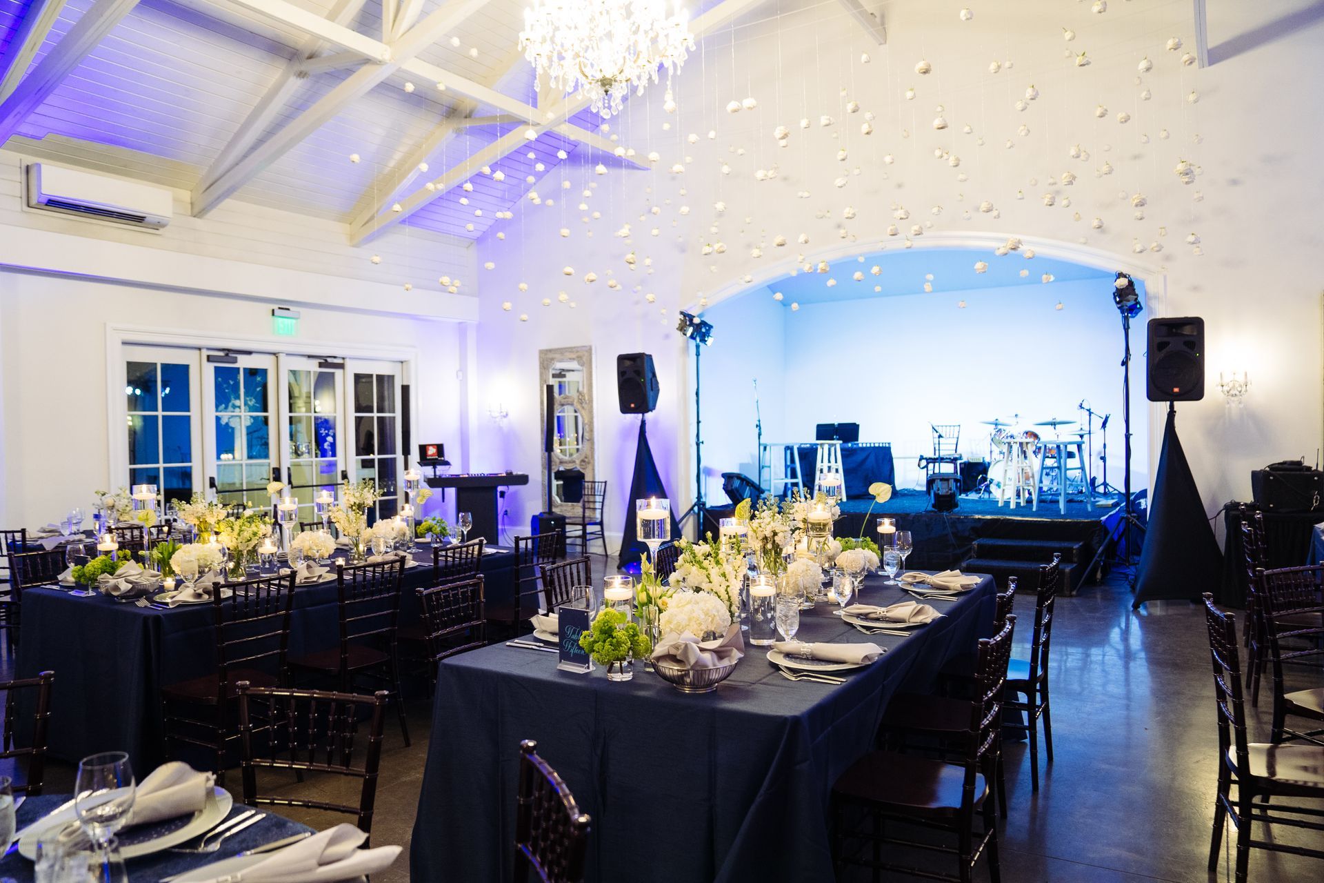 Corporate Event dinner at The Merrimon-Wynne House in Raleigh, NC with long tables and white florals. 