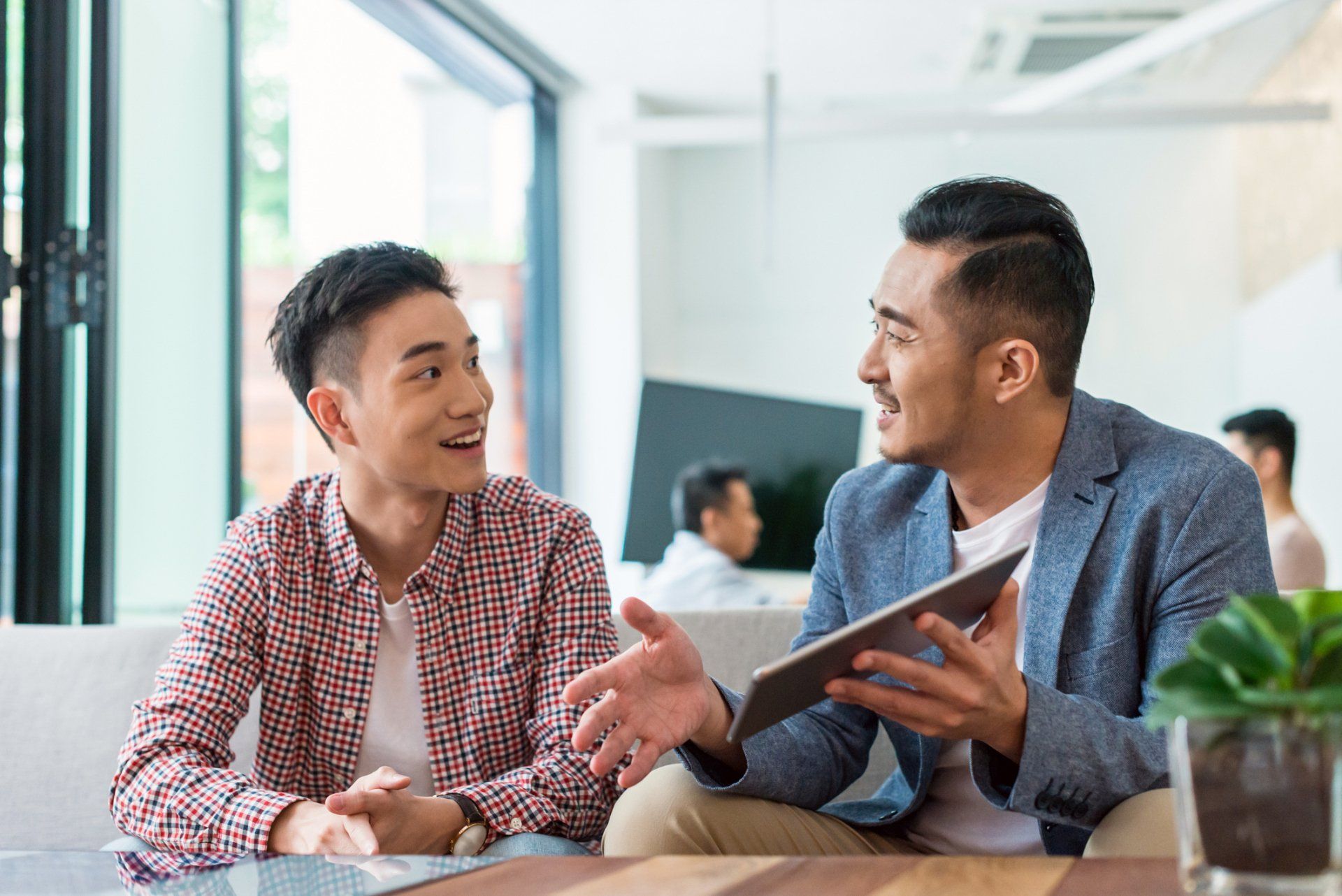 asian young people talking about business
