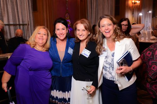 Four women stand together and smile and NAWL's Annual Meeting.