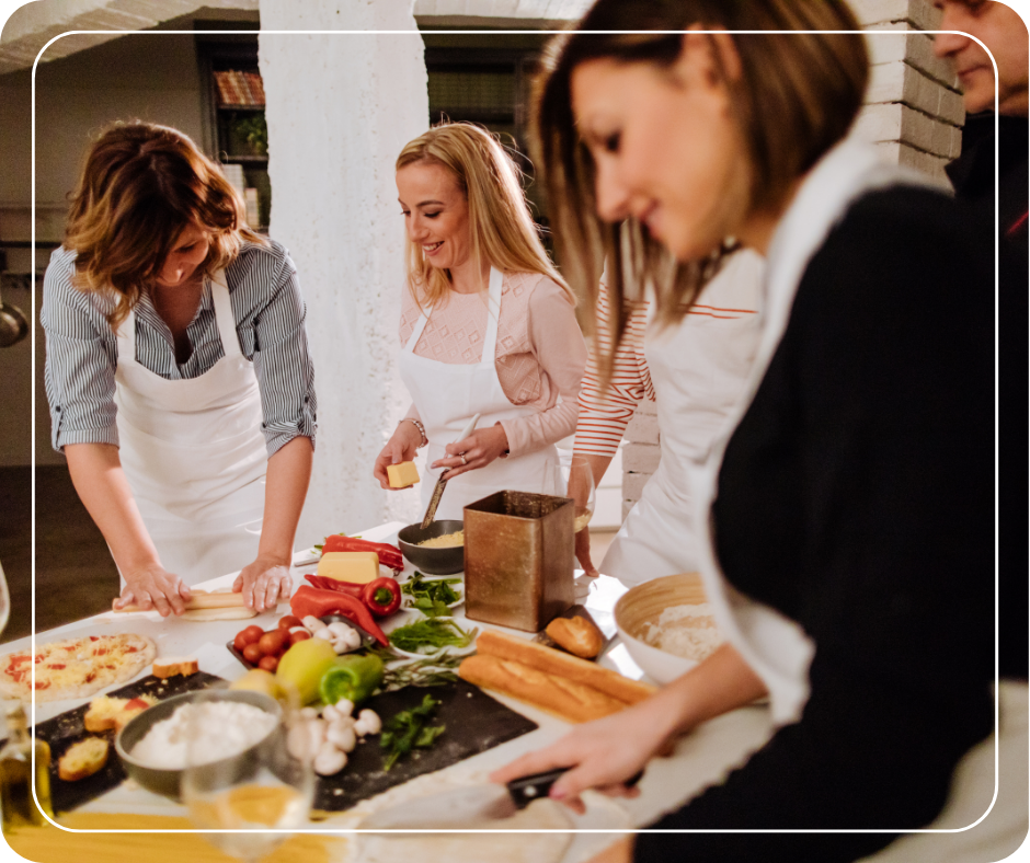 Women preparing food around a counter.