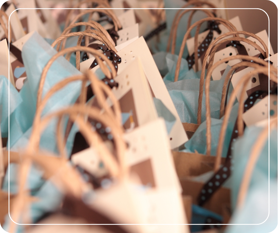 Gift bags lined up on a table.