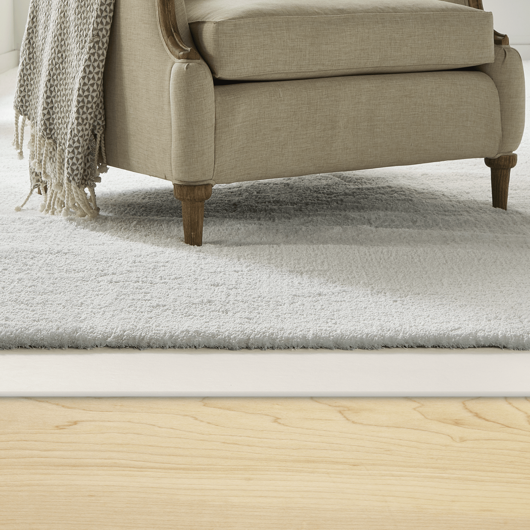Room scene with Healthier Choice Carpet Cushion with carpet and chair. Image shows exposed carpet pad.