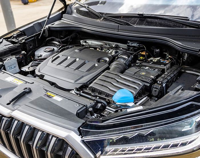 The engine of a car is shown with the hood open.