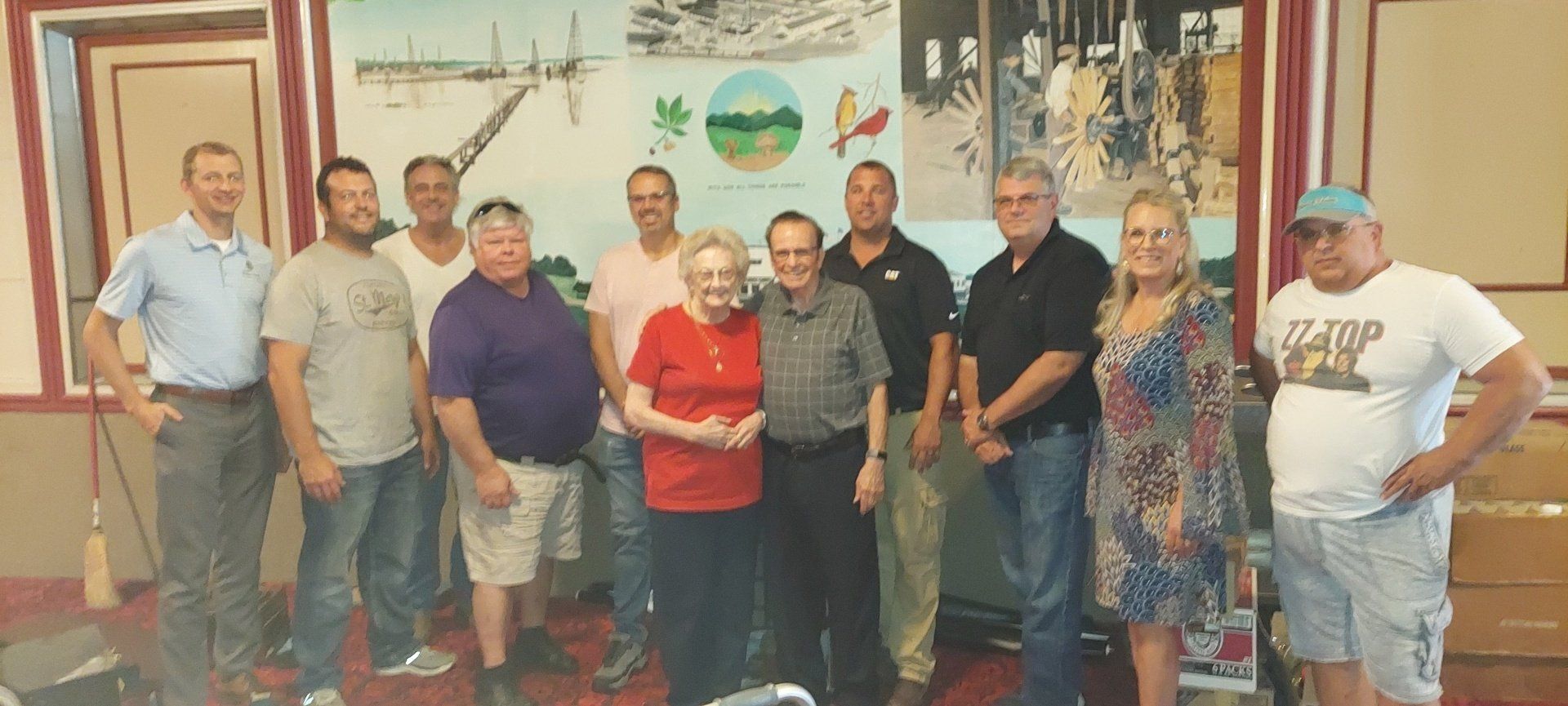 A group of people are posing for a picture in a room.