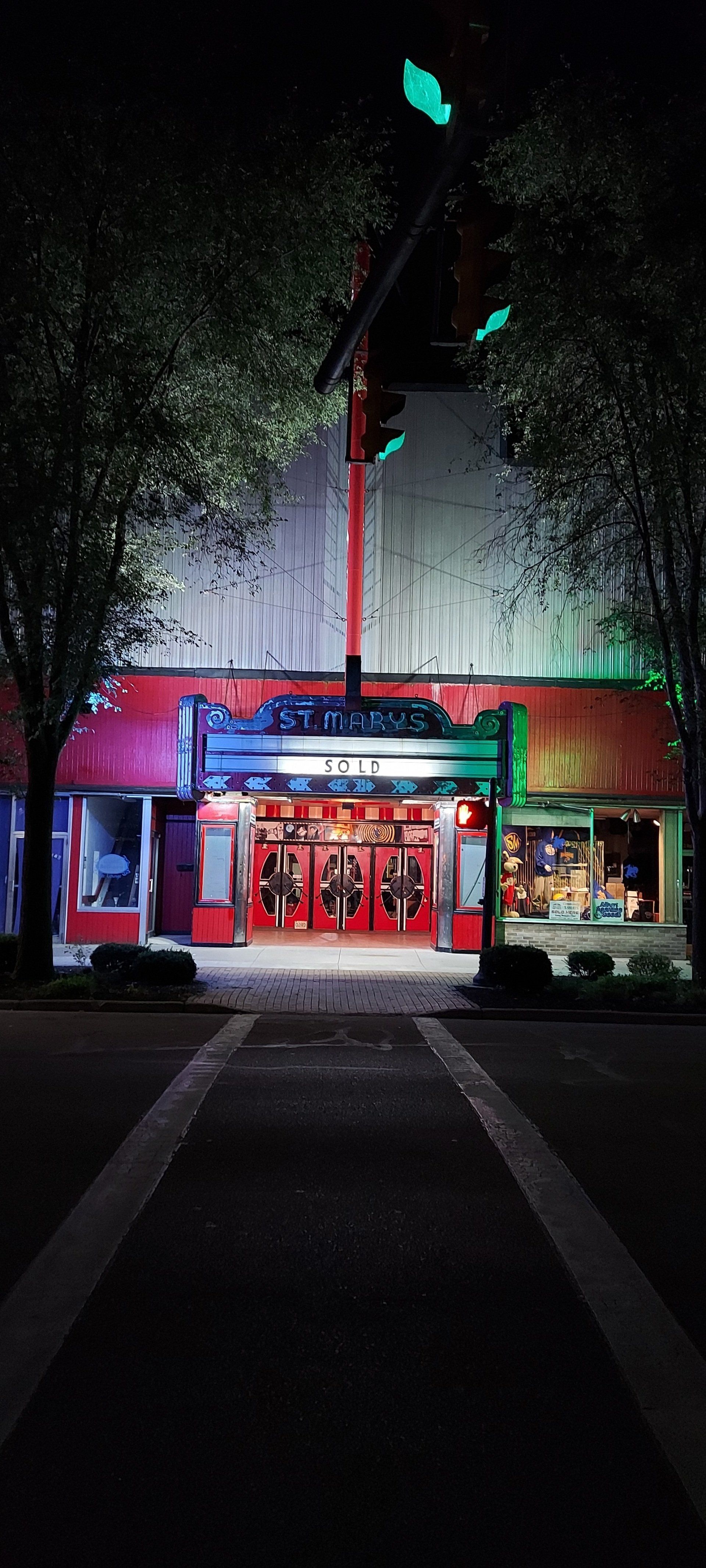 The entrance to a movie theater is lit up at night.