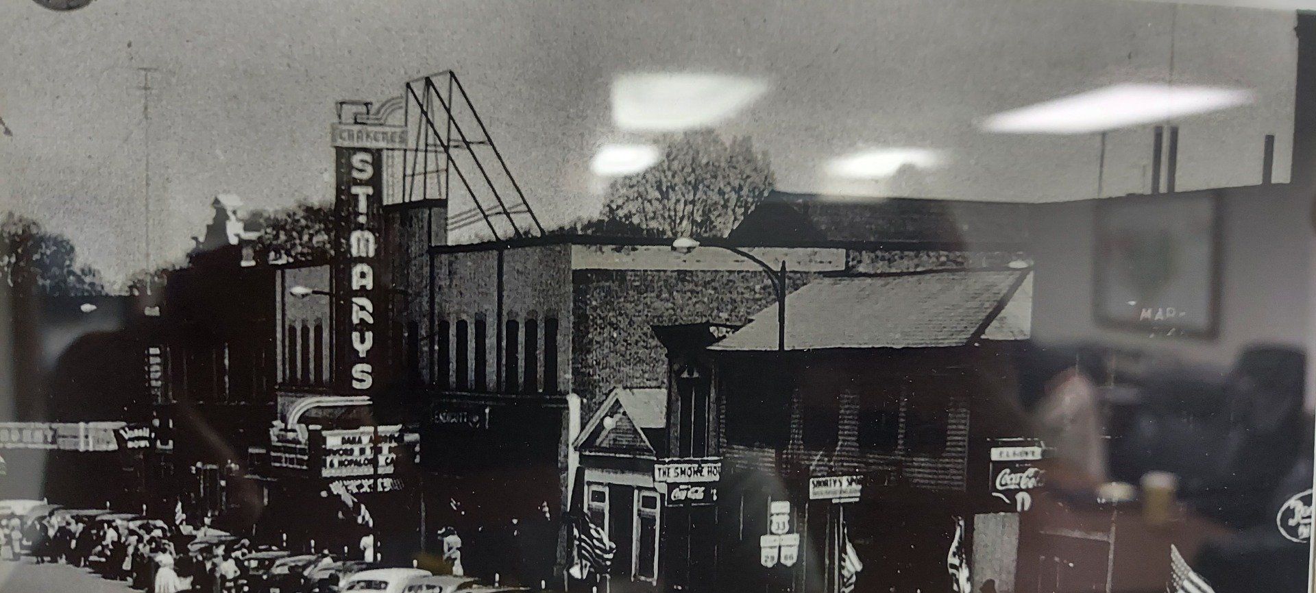 A black and white photo of a building with a sign that says starbucks