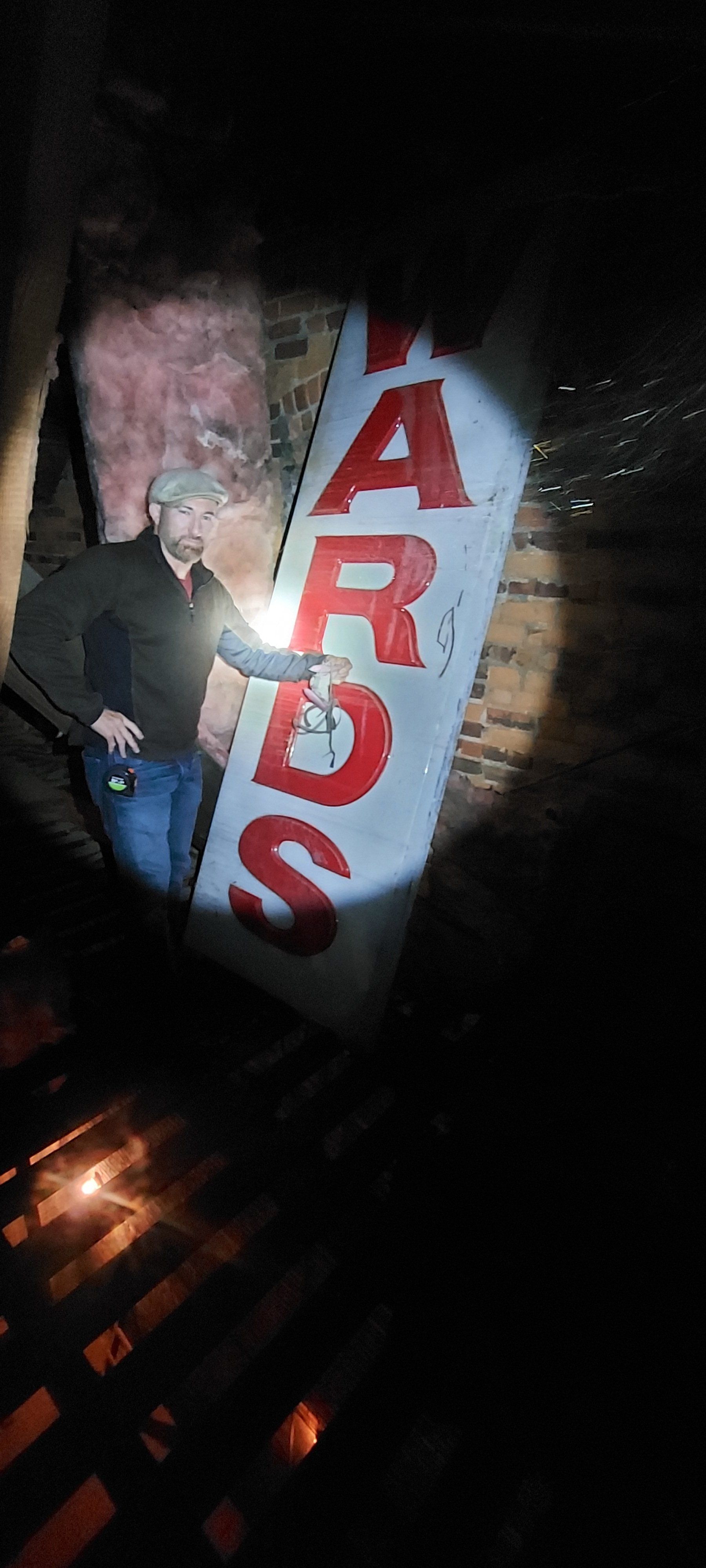 A man is standing in front of a sign that says `` sdra ''.