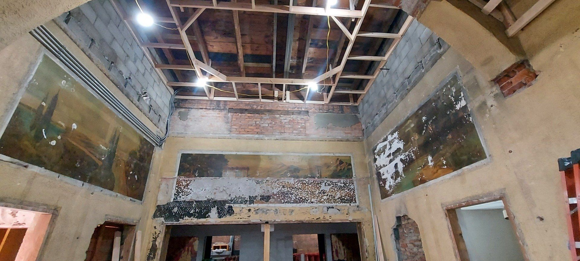 A large room with a ceiling that is being remodeled.