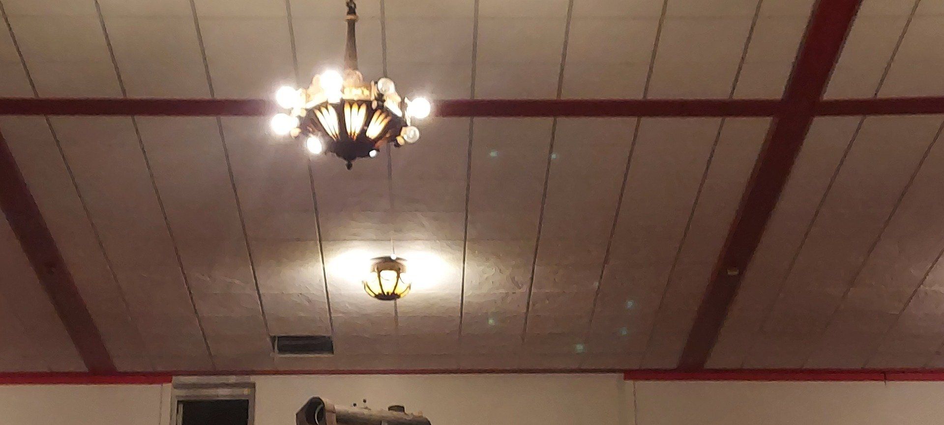 A chandelier is hanging from the ceiling of a room.