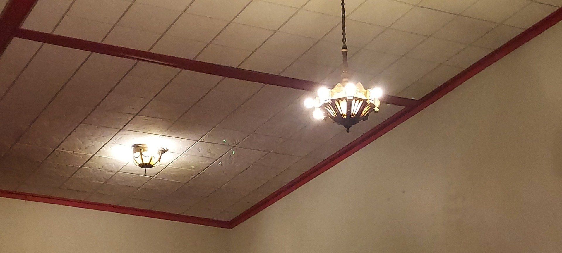 A chandelier is hanging from the ceiling of a room.