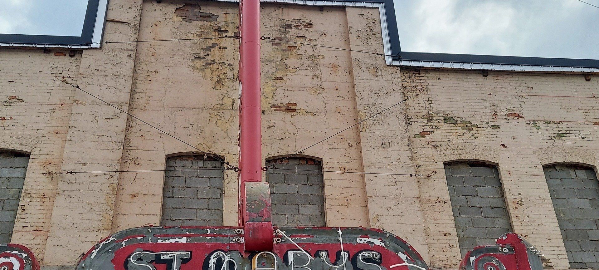 A brick building with a sign that says ' stop ' on it