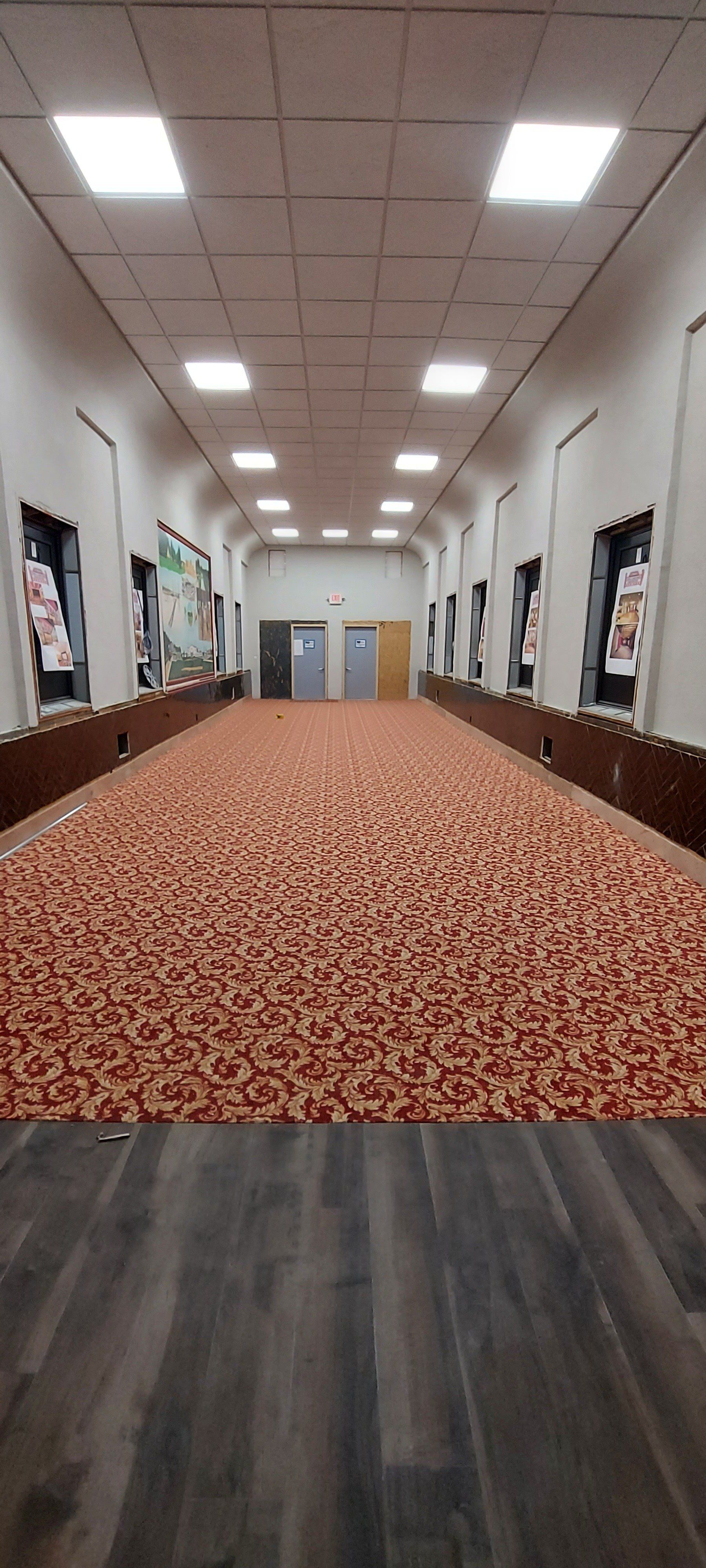 A long hallway with a lot of nuts on the floor.