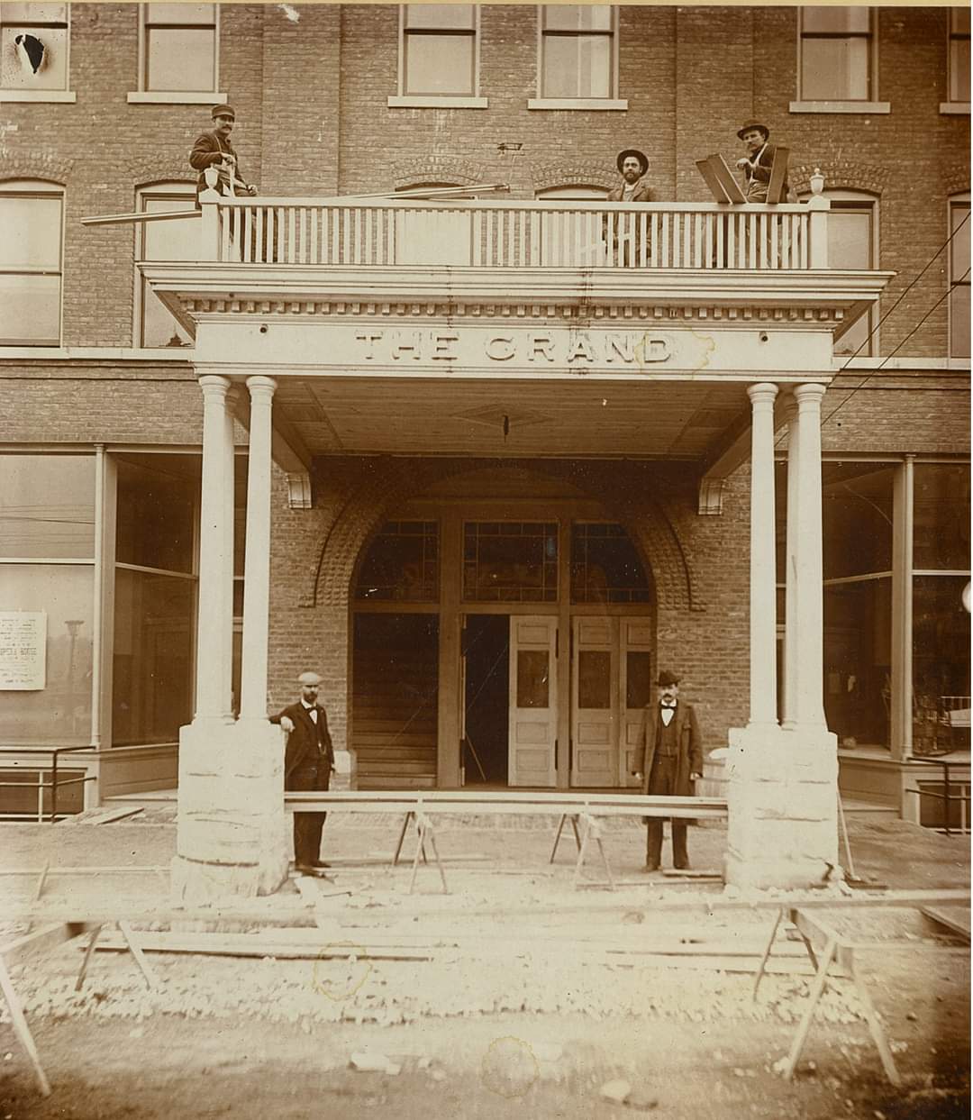 A black and white photo of a building with the word the on it