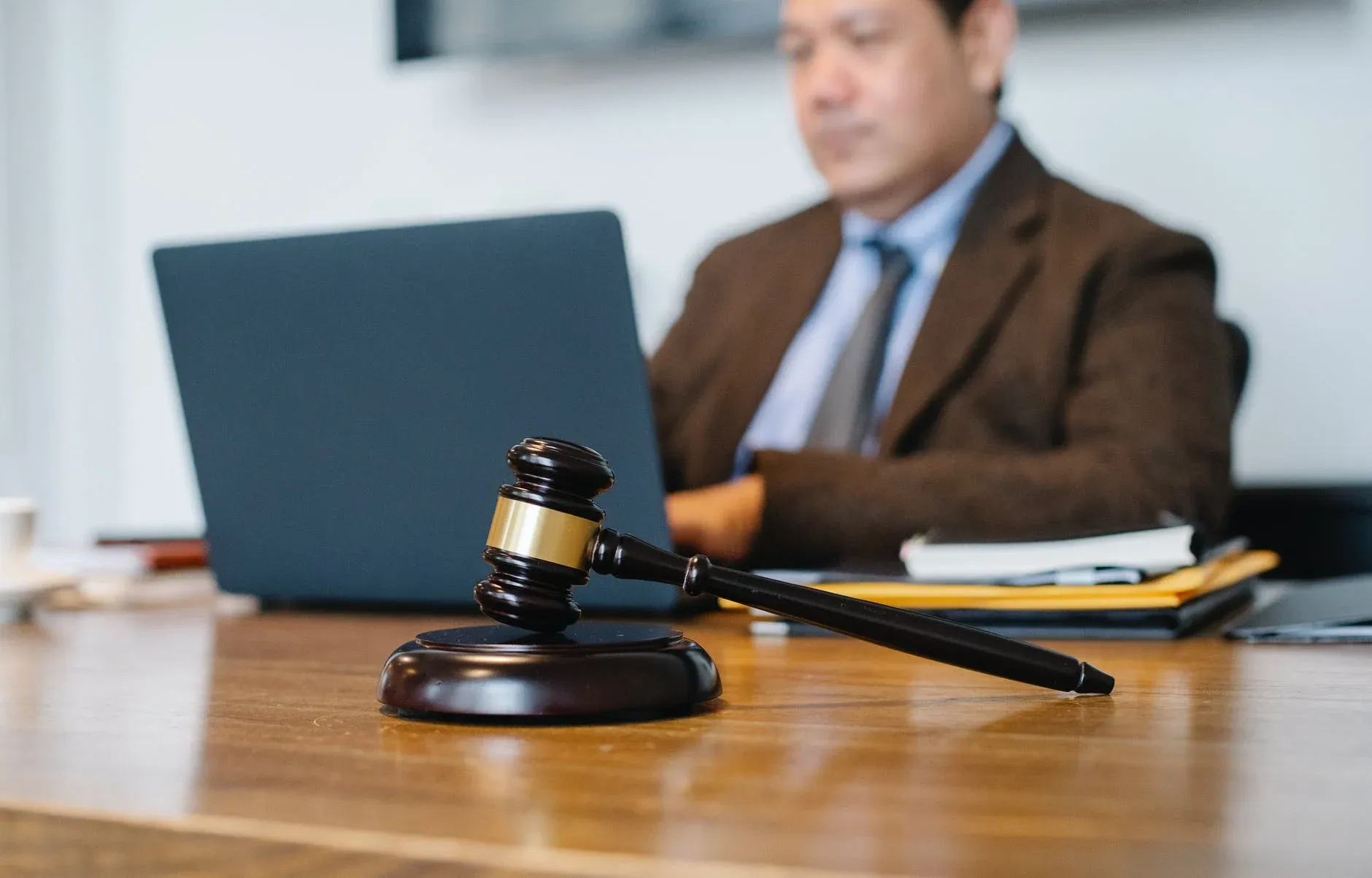 crop-asian-judge-working-on-laptop-in-office